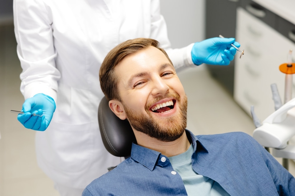Portrait,Of,Happy,Man,Sitting,At,Dentist,Chair,In,Modern Dental Implants in Brooklyn